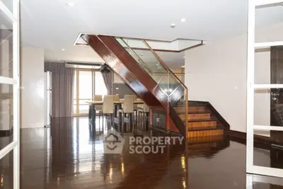 Spacious modern living area with elegant staircase and dining space