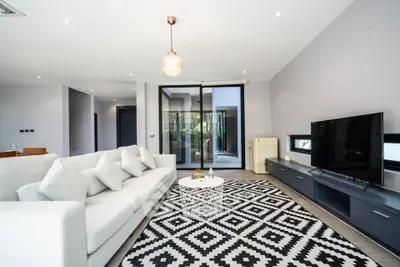 Spacious modern living room with stylish decor and large windows