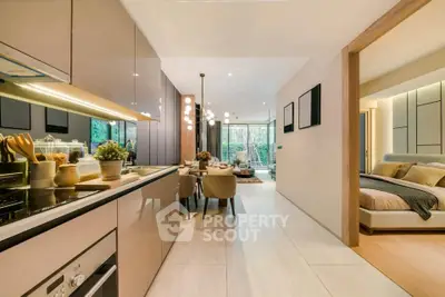 Luxurious open-plan kitchen and dining area with modern decor and spacious bedroom view.