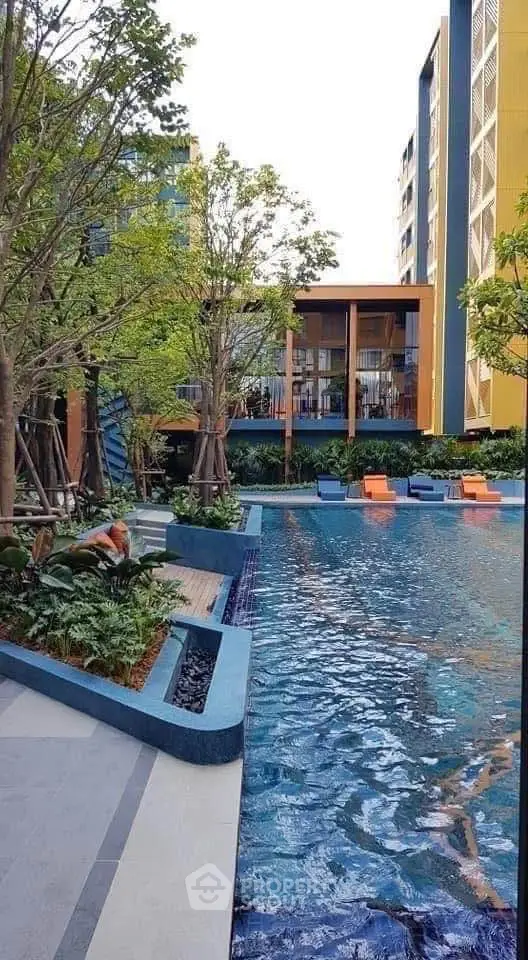 Luxurious residential pool area with modern design and lush greenery, perfect for relaxation and leisure.