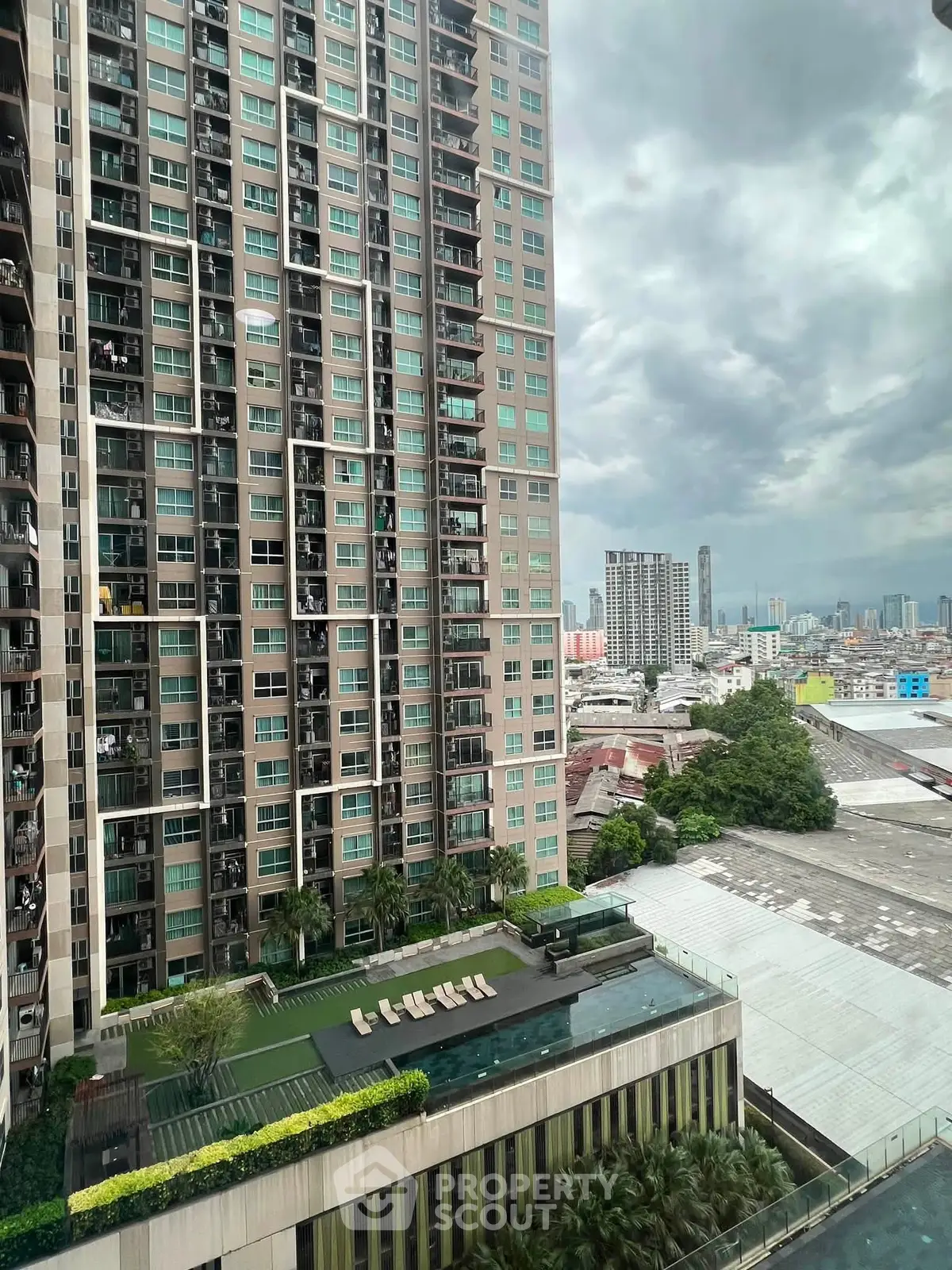 Stunning high-rise building with pool and city view, perfect for urban living.