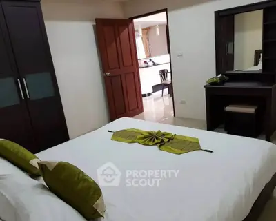 Cozy bedroom with elegant decor and a view into a modern living area, perfect for comfortable living.