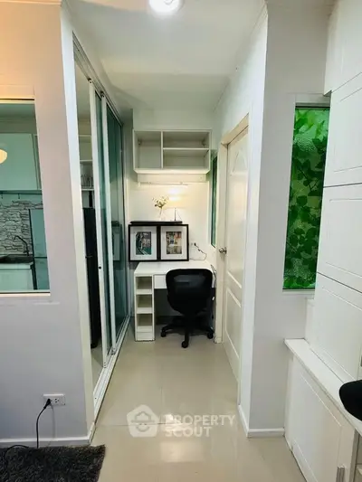 Cozy study nook with modern desk and chair in a bright, compact space, perfect for productivity.