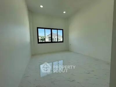Spacious empty room with large window and marble flooring, perfect for customization.