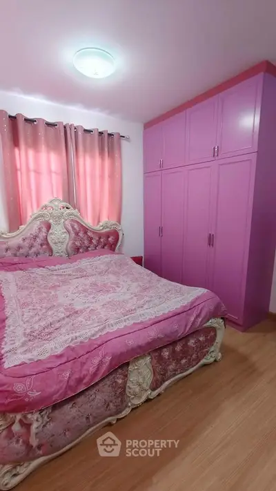 Charming bedroom with elegant pink decor and spacious wardrobe