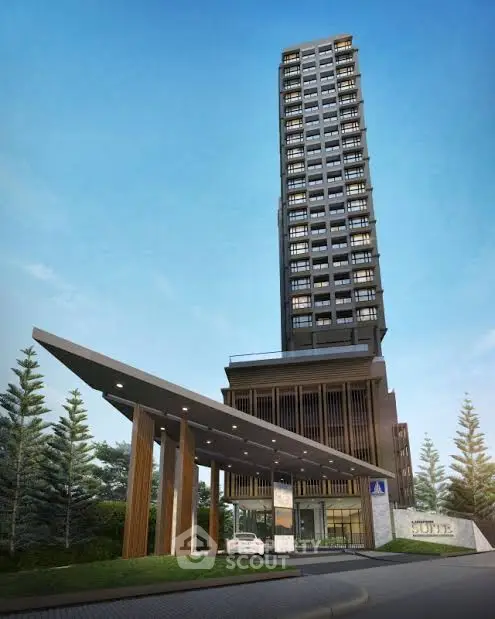 Modern high-rise building with sleek entrance and lush greenery