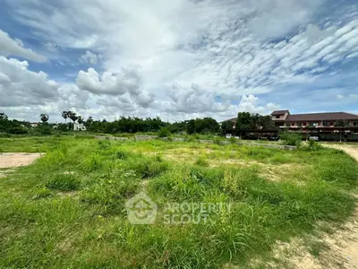 Expansive green land with potential for development under a vast sky.
