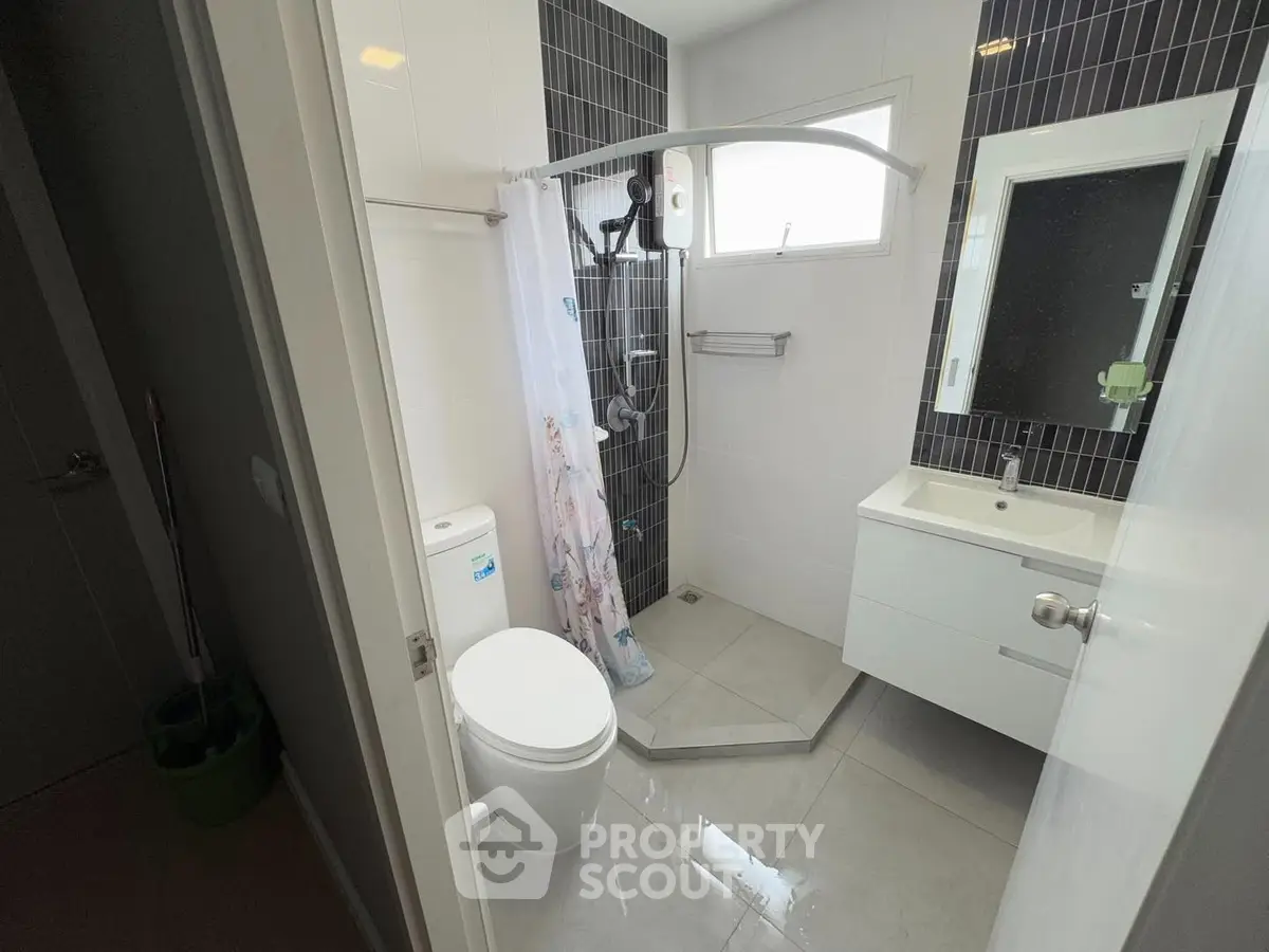 Modern bathroom with sleek fixtures and a spacious shower area.
