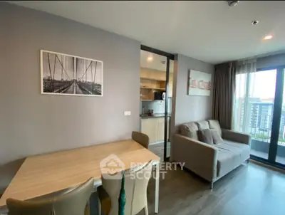 Modern living room with dining area and balcony view in a stylish apartment.