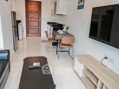 Modern open-layout kitchen and living area with sleek furniture and appliances.