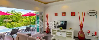 Luxurious living room with pool view and modern decor, perfect for relaxation and entertainment.
