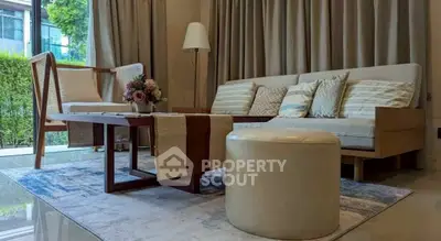 Stylish living room with modern furniture and large window view.