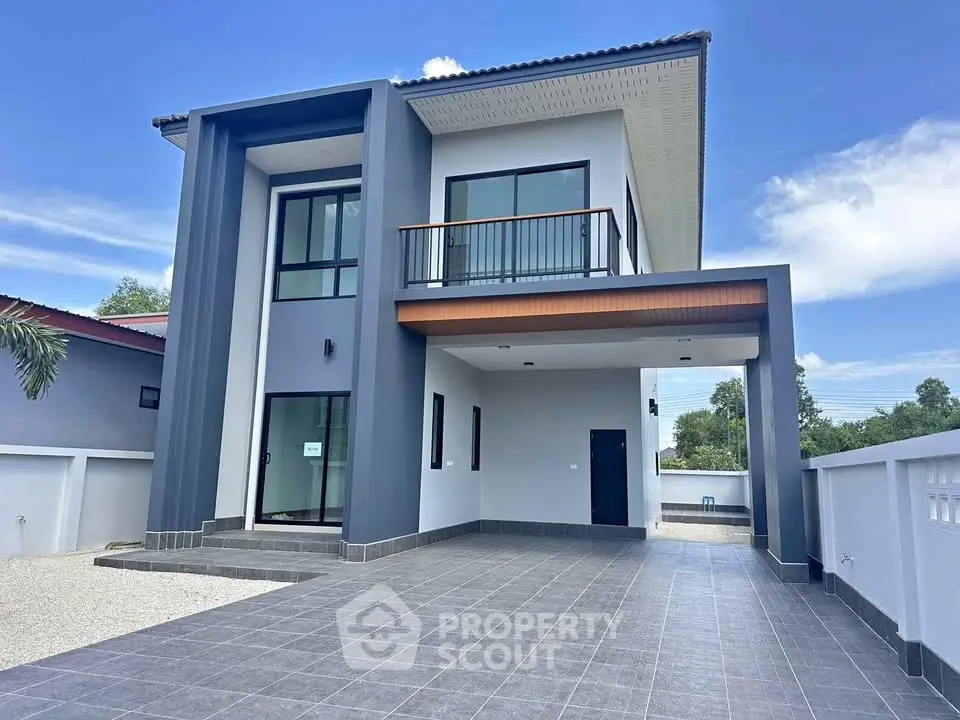 Modern two-story house with spacious driveway and sleek design