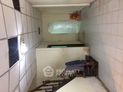 Spacious hallway with tiled flooring and staircase in residential property