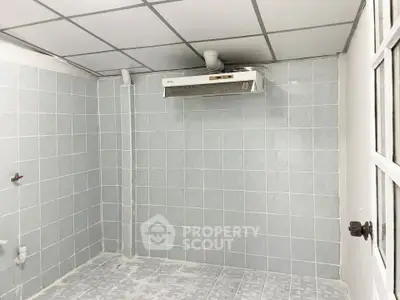 Unfurnished tiled room with ceiling exhaust fan, ideal for utility or storage use.