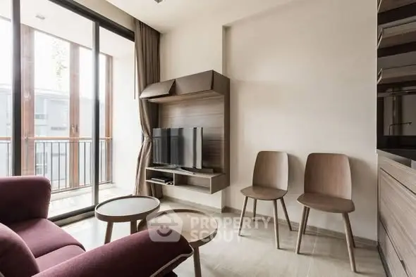 Modern living room with stylish furniture and large windows for natural light.