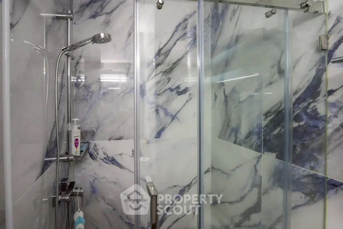 Modern bathroom with sleek marble shower and glass doors