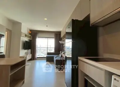 Modern open-layout living room with kitchen and city view balcony.