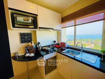 Modern kitchen with ocean view, featuring sleek appliances and ample natural light.