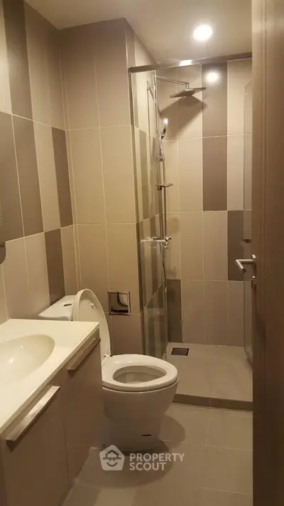 Modern bathroom with sleek shower and neutral tiles