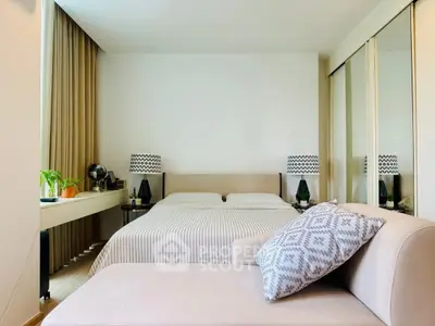 Elegant bedroom with modern decor and ample natural light, featuring a cozy bed and stylish furnishings.