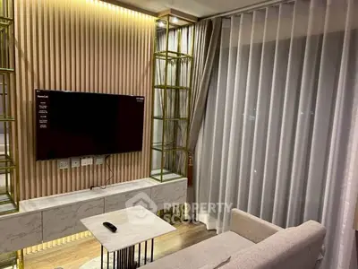 Modern living room with sleek TV setup and elegant curtains