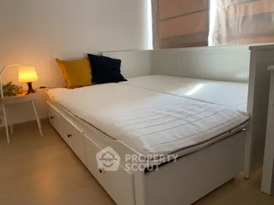 Cozy bedroom with modern bed and soft lighting, perfect for relaxation.