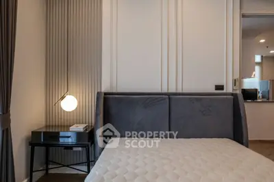 Modern bedroom with stylish bed and elegant lighting in a contemporary apartment.