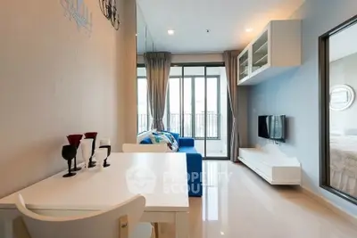 Modern living room with sleek design and balcony access, featuring stylish furniture and ample natural light.