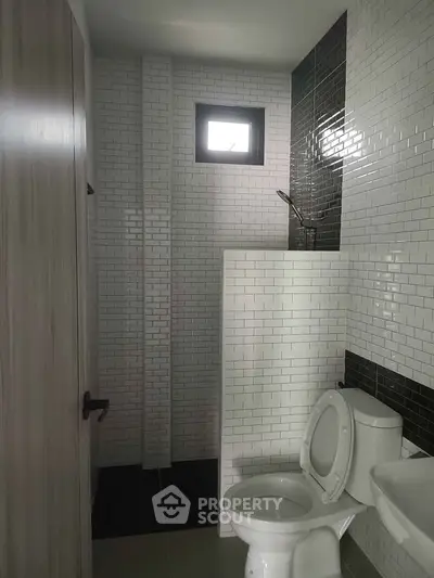 Modern bathroom with sleek tile design and compact layout