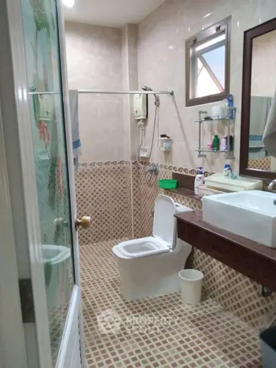 Spacious bathroom with modern fixtures and elegant tile design