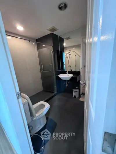 Modern bathroom with glass shower and sleek fixtures