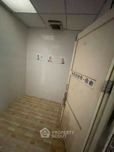 Small, empty room with tiled floor and white walls, suitable for storage or utility use.