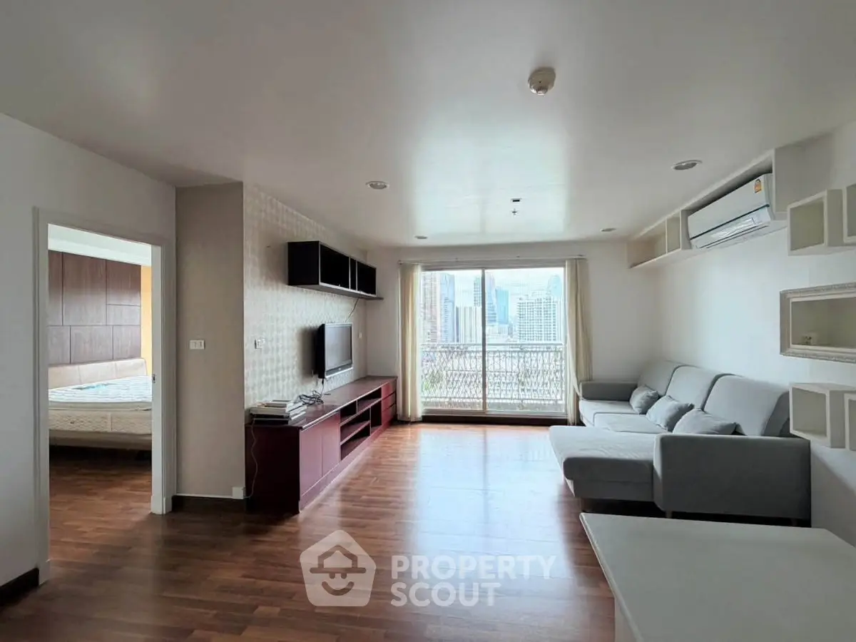 Spacious modern living room with city view and sleek furnishings