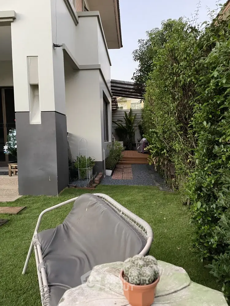 Charming garden view with modern exterior and lush greenery