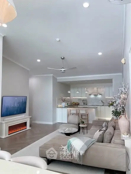 Modern living room with open kitchen, stylish decor, and cozy ambiance.