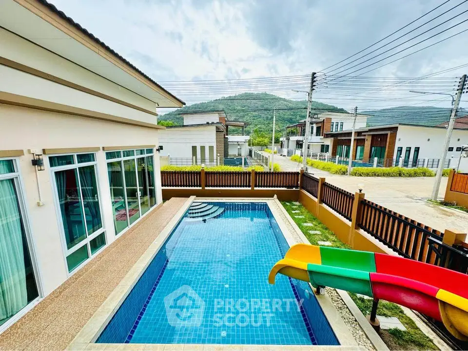 Modern villa with private pool and mountain view in serene neighborhood.