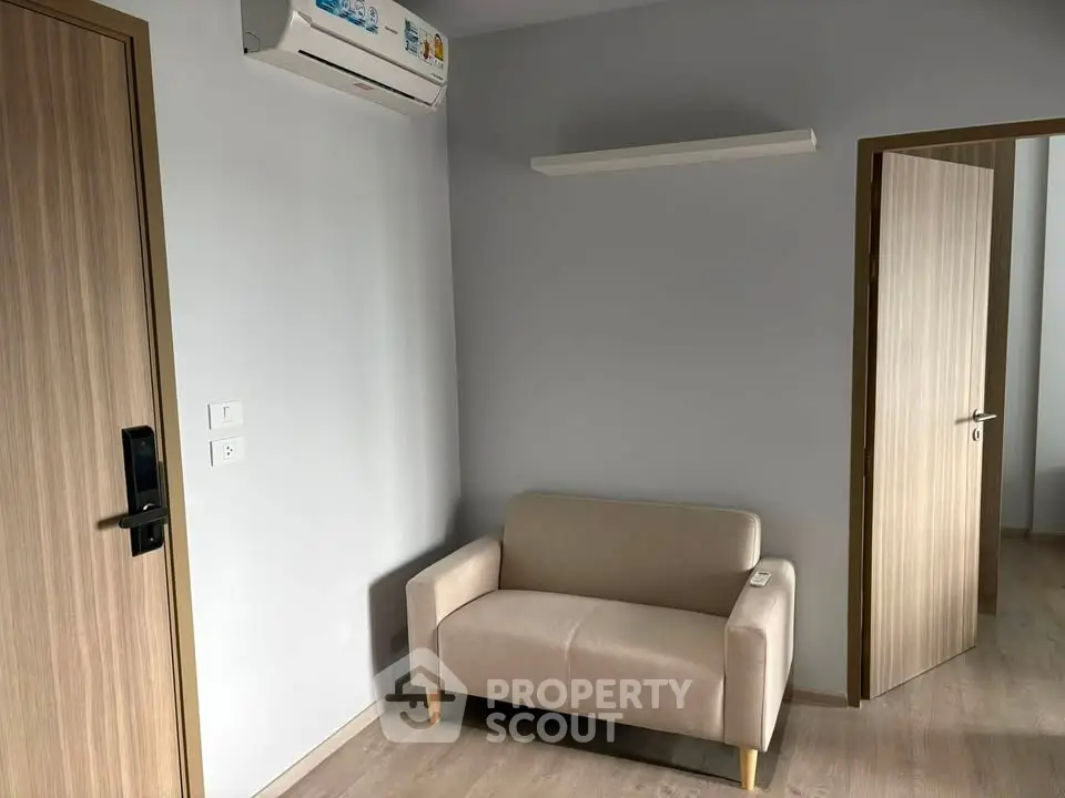 Modern minimalist living room with beige sofa and air conditioning