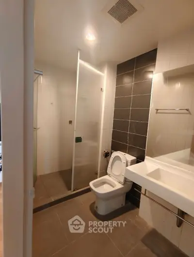 Modern bathroom with glass shower and sleek fixtures