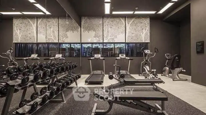 Modern gym with state-of-the-art equipment and stylish decor in a luxury residential building.