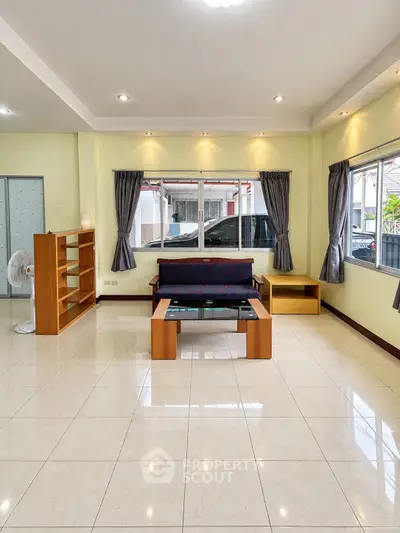 Spacious living room with modern furniture and large windows offering natural light.