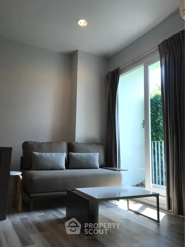 Bright living room with modern sofa and large window for natural light.