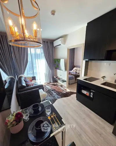 Modern open-plan living room with stylish kitchen and cozy bedroom view