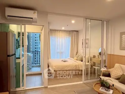 Modern studio apartment with cozy bedroom and open living space, featuring a balcony view.