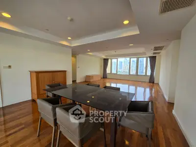 Spacious modern living room with city view, hardwood floors, and elegant dining area.