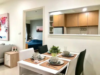 Modern open-plan living and dining area with stylish decor and cozy ambiance.