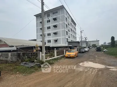 Explore this multi-story residential building with ample parking and urban surroundings.