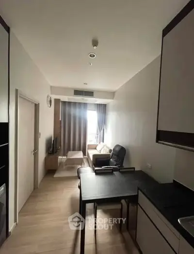 Modern apartment interior with cozy living area and sleek kitchen design.