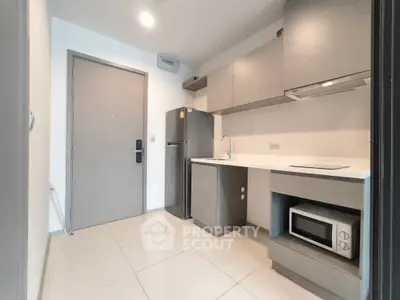 Modern kitchen with sleek cabinetry and built-in appliances in a compact layout.