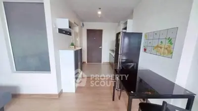Modern apartment interior with sleek kitchen and dining area, featuring stylish decor and ample natural light.